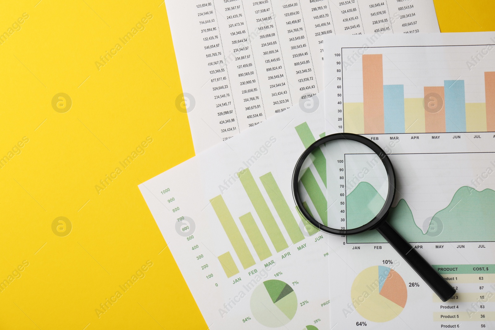 Photo of Accounting documents and magnifying glass on yellow background, top view. Space for text