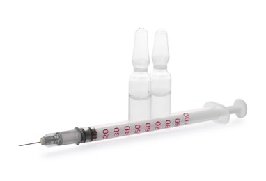 Disposable syringe with needle and ampules isolated on white