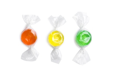 Different delicious colorful candies on white background, top view