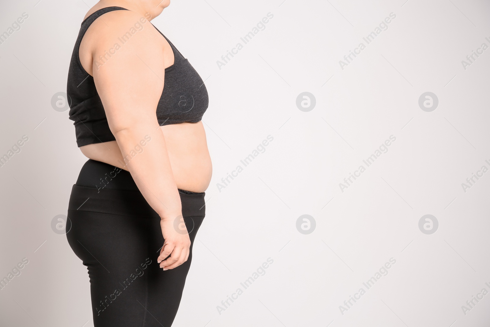 Photo of Overweight woman on light background