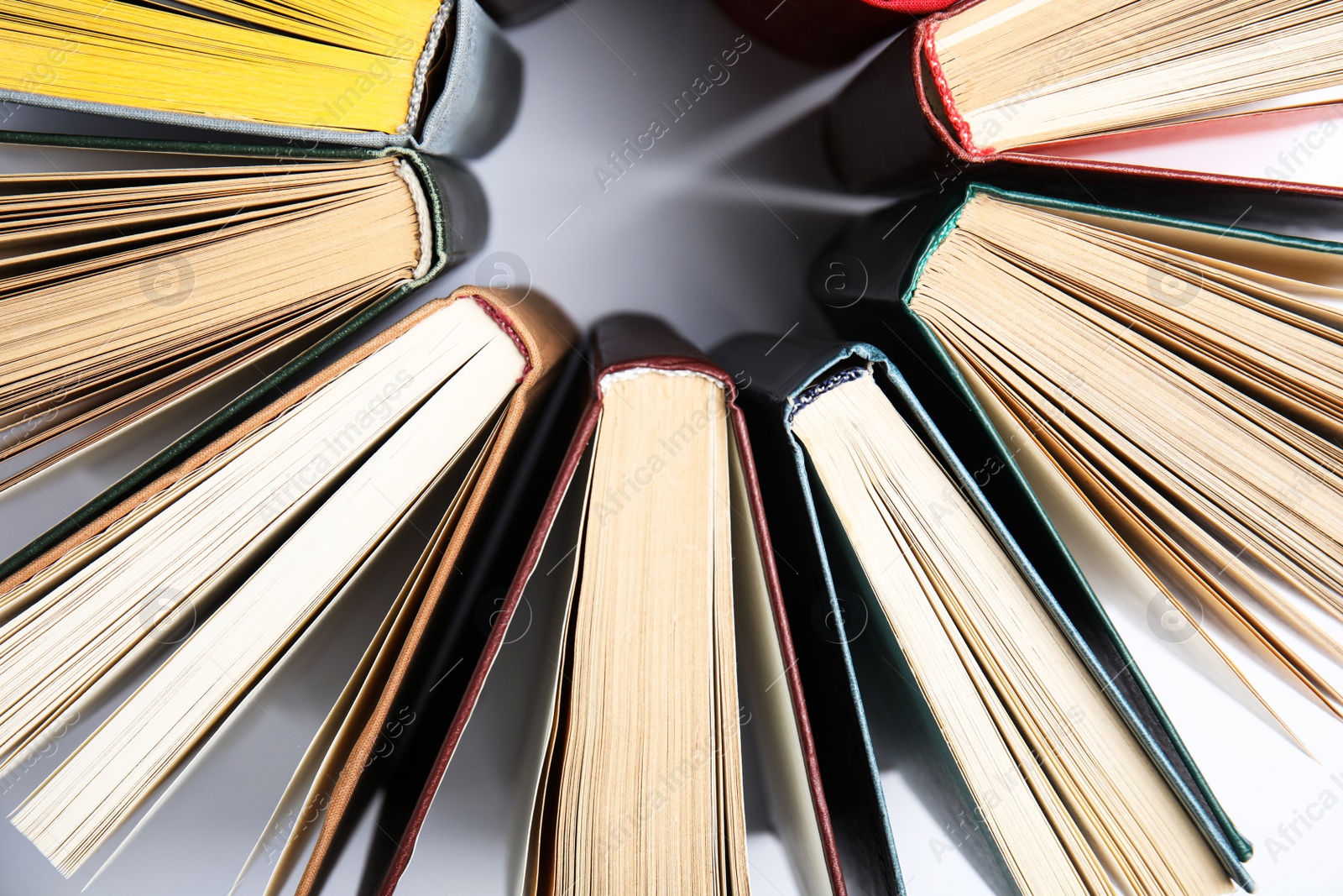 Photo of Circle made of hardcover books on white background, flat lay