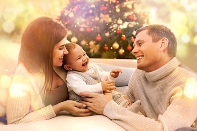 Image of Happy couple with cute baby in living room decorated for Christmas. Magical festive atmosphere