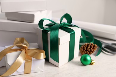 Photo of Beautiful gift boxes and Christmas decorations on white table