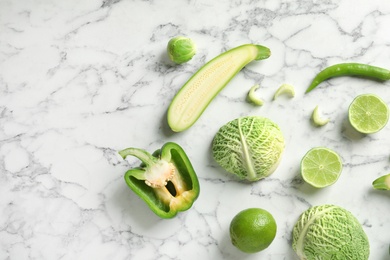 Flat lay composition with fresh vegetables and fruit on marble background