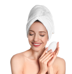 Beautiful young woman with soap bar on white background