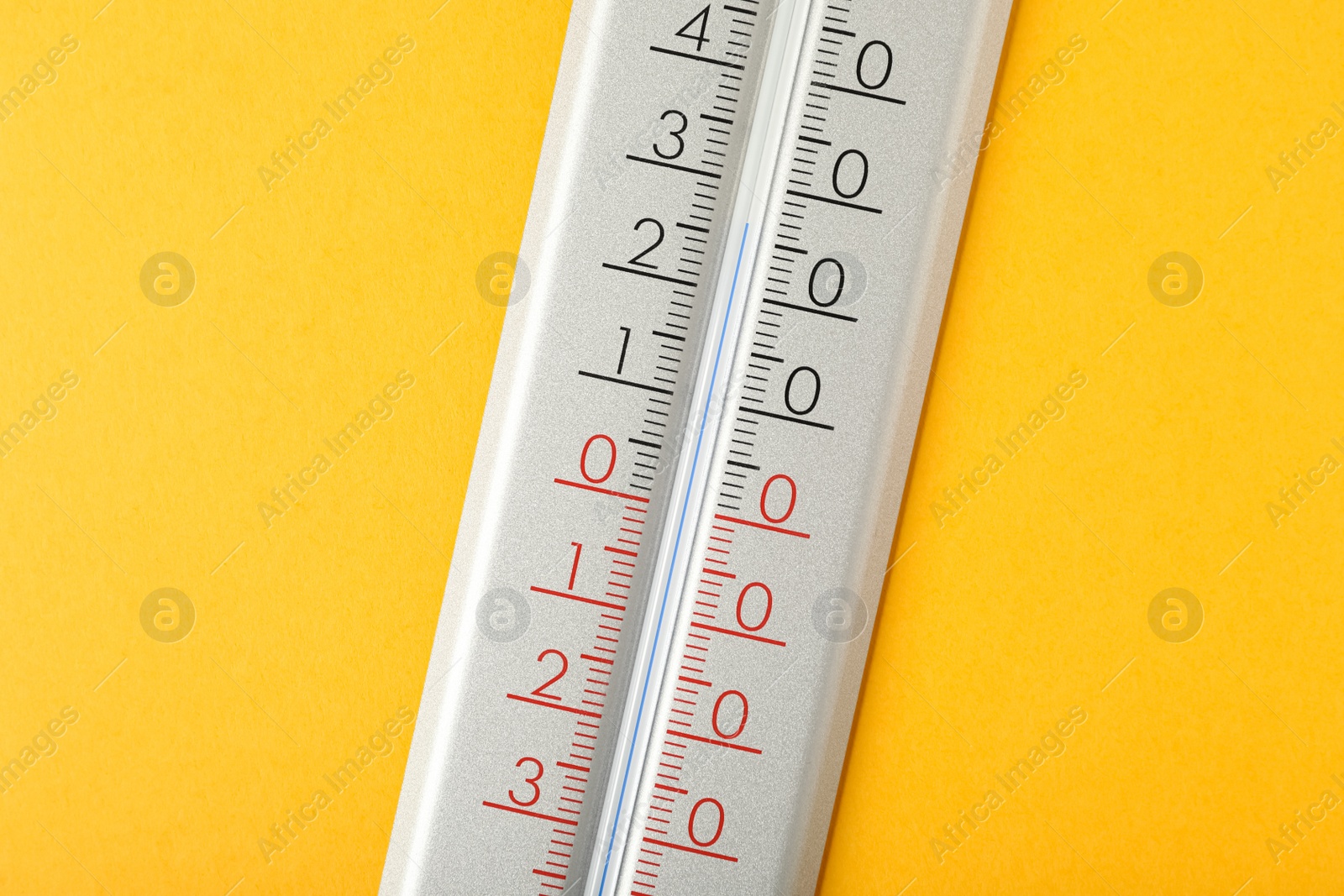 Photo of Modern weather thermometer on yellow background, closeup