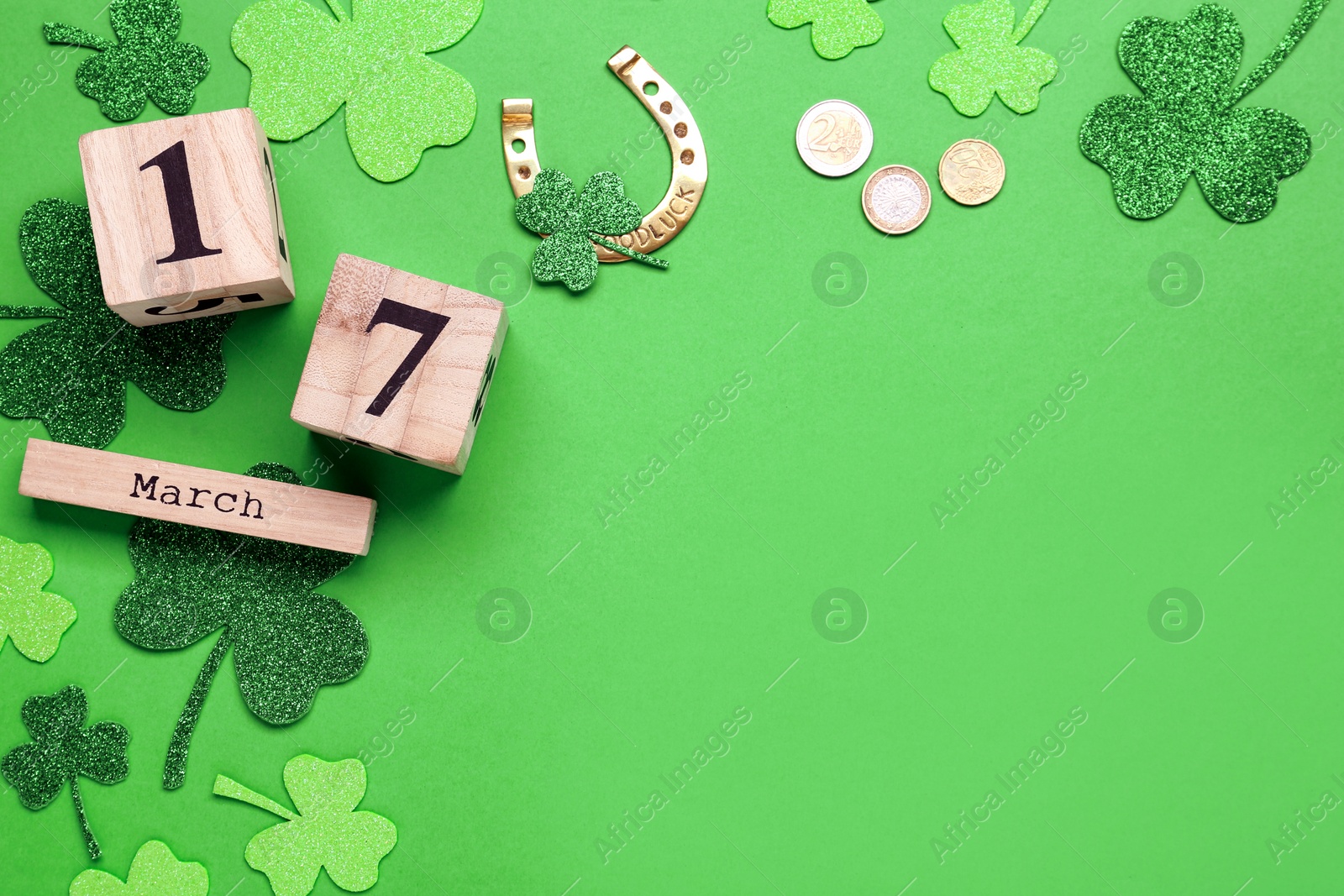 Photo of Flat lay composition with block calendar on green background, space for text. Saint Patrick's Day celebration