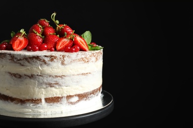 Photo of Delicious homemade cake with fresh berries on black background, closeup