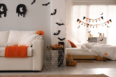 Stylish room interior with creative Halloween decor