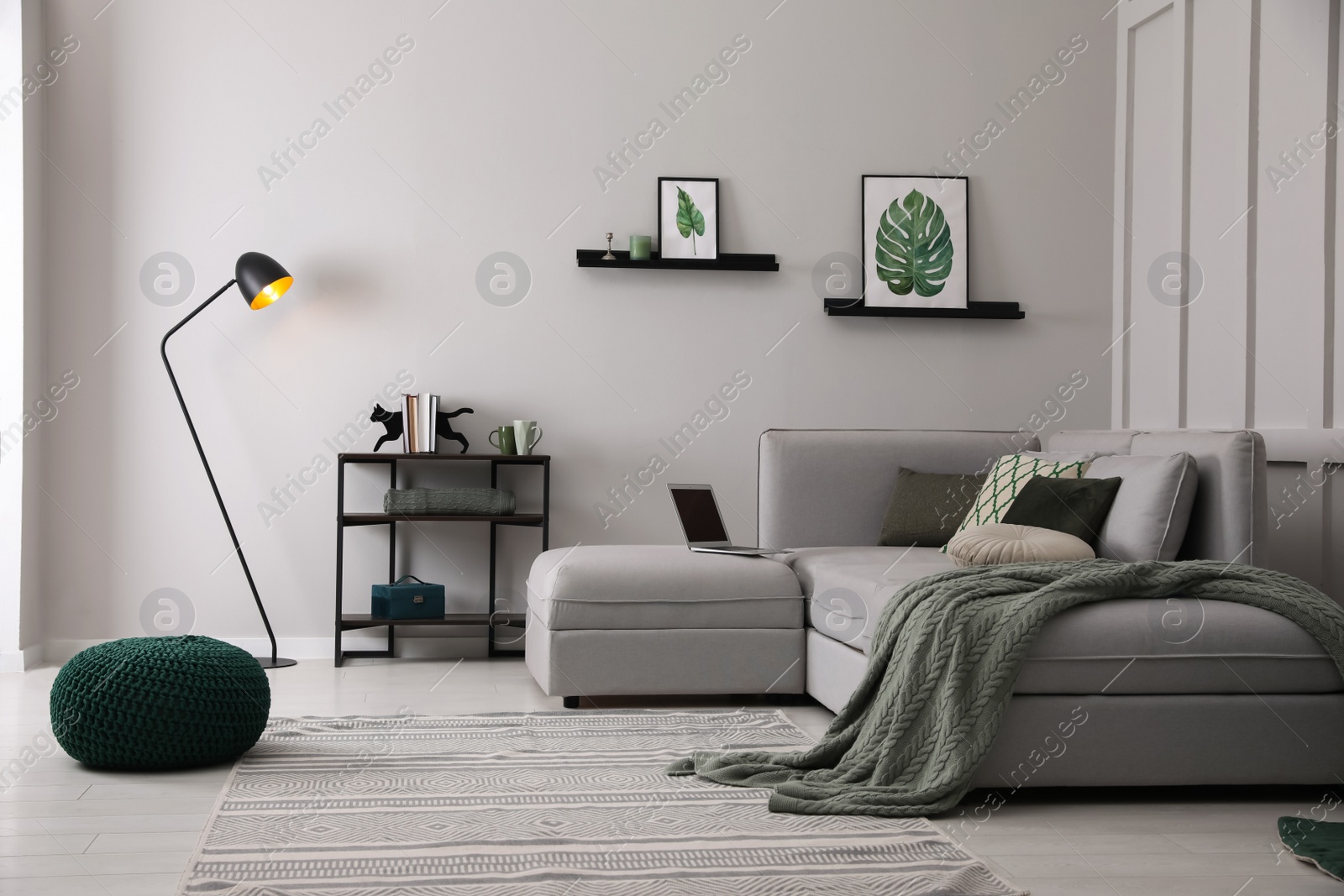 Photo of Living room with comfortable grey sofa and stylish interior elements