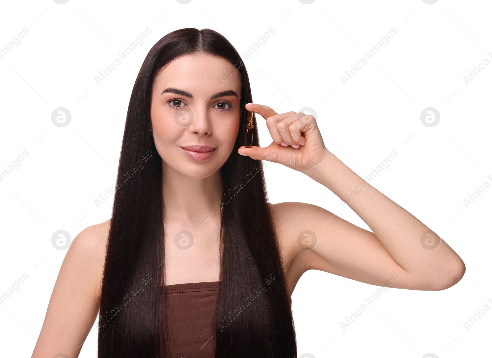 Photo of Beautiful young woman holding skincare ampoule on white background