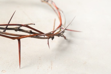 Crown of thorns on light background, closeup with space for text. Easter attribute