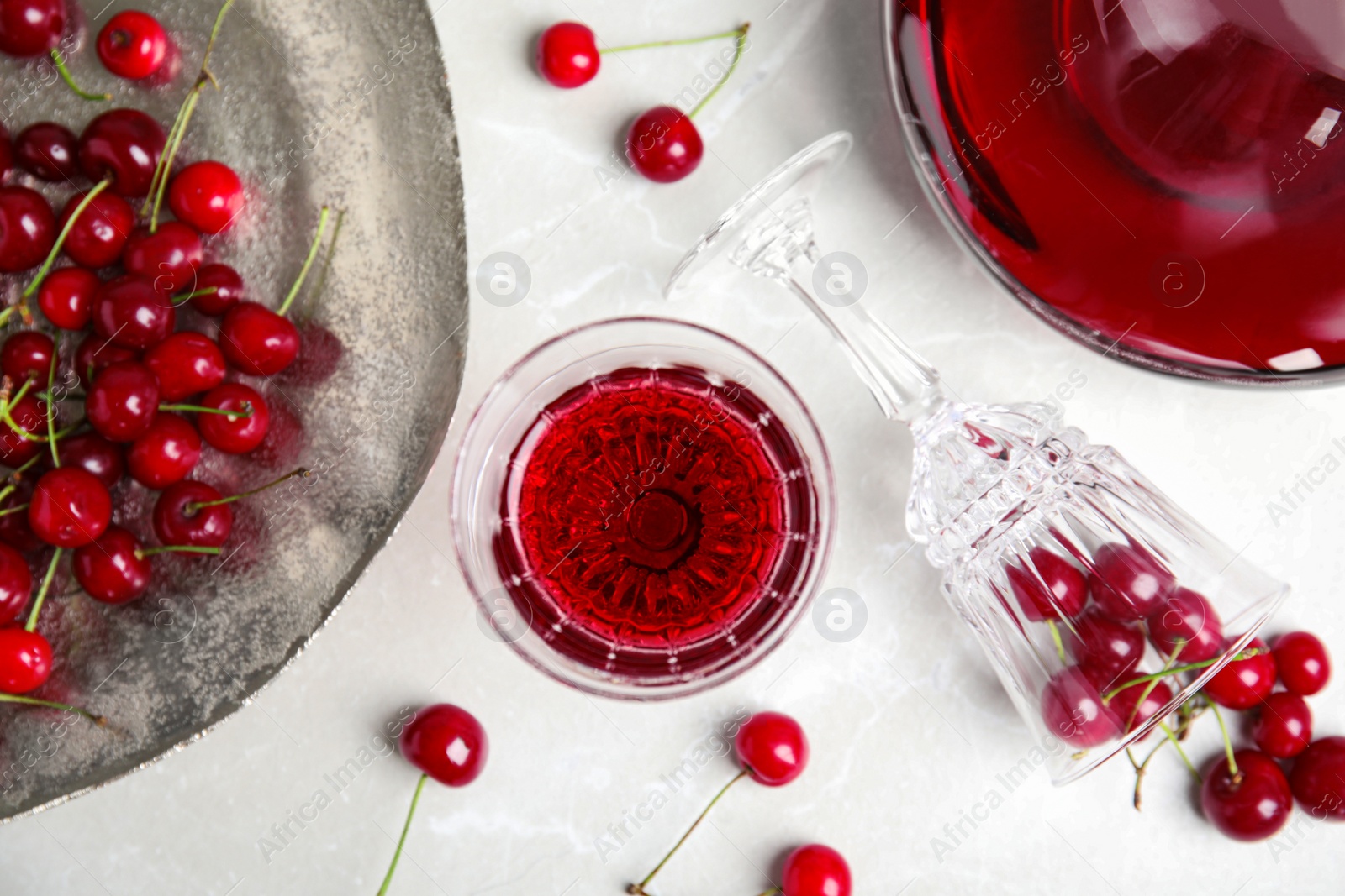 Photo of Delicious cherry wine and ripe juicy berries on white table, flat lay