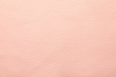Texture of light pink leather as background, closeup
