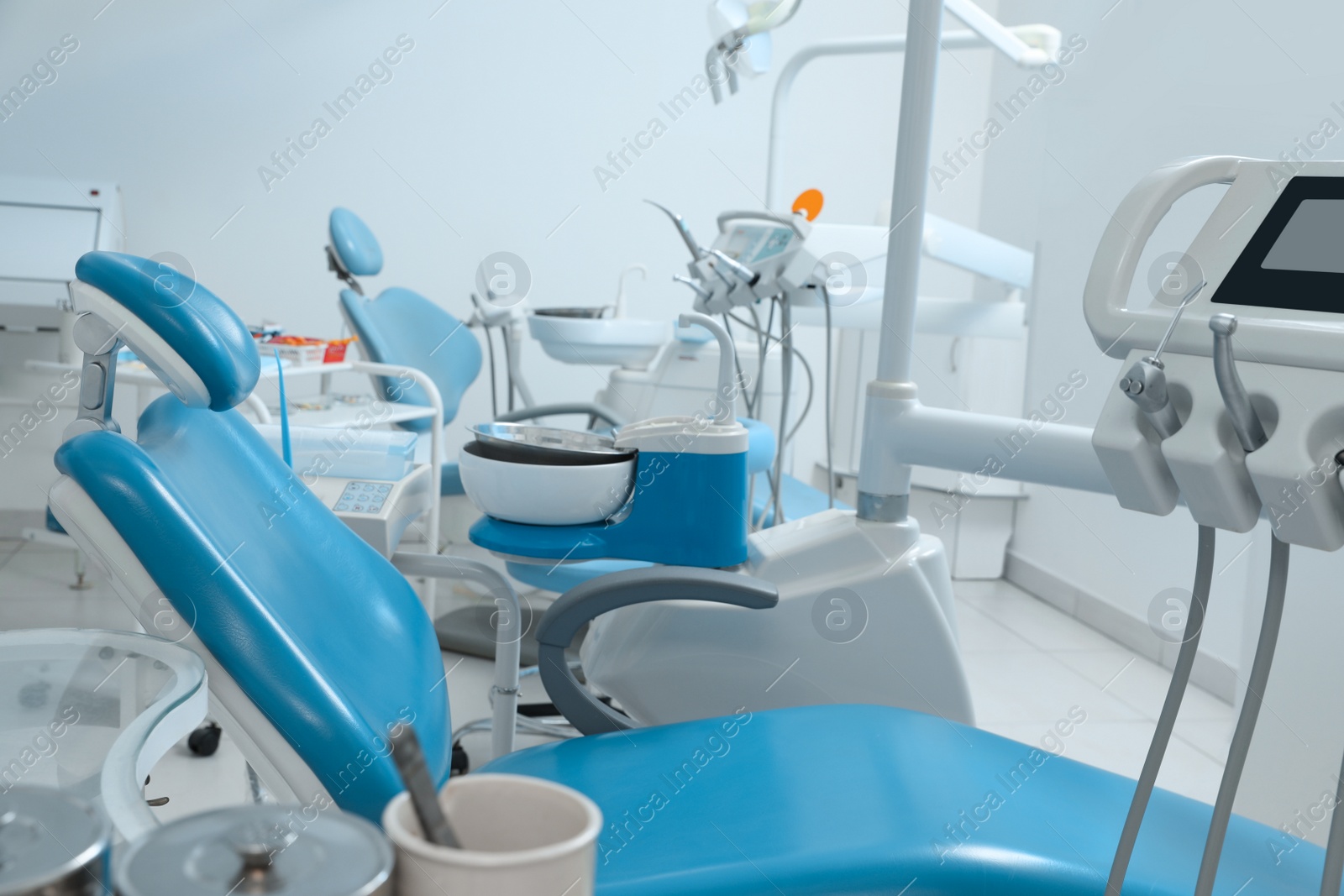 Photo of Dentist's office interior with chair and modern equipment