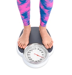 Photo of Young woman measuring her weight using scales on white background. Weight loss motivation