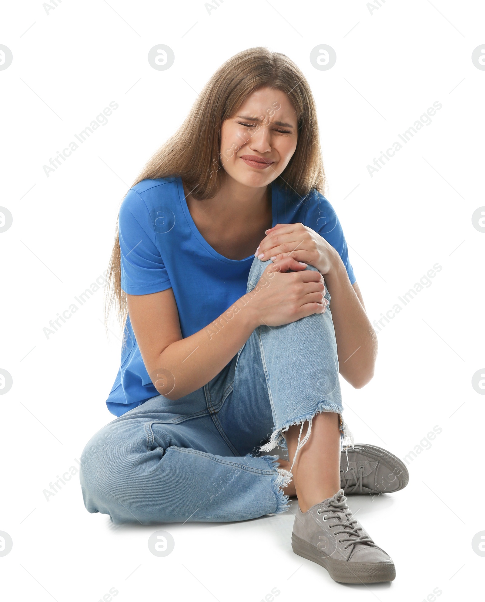 Photo of Full length portrait of woman with knee problems sitting on white background