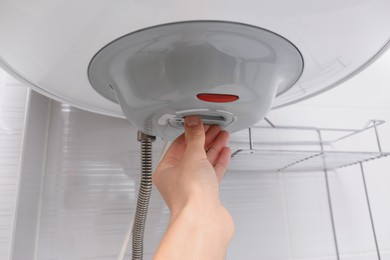 Photo of Woman adjusting maximum energy efficiency indicator indoors, closeup. Boiler installation