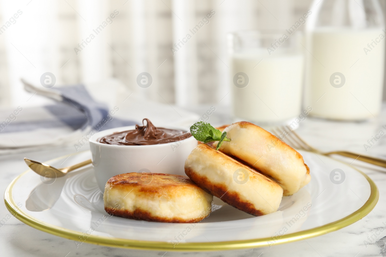 Photo of Delicious cottage cheese pancakes with chocolate paste on plate, closeup