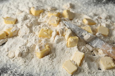 Making shortcrust pastry. Flour, butter and knife on table, closeup