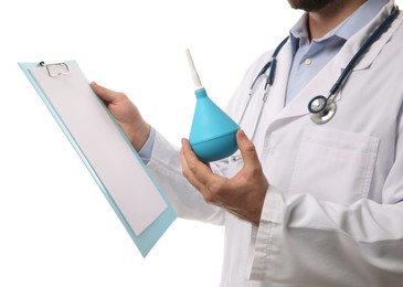 Photo of Doctor holding light blue enema and clipboard on white background, closeup
