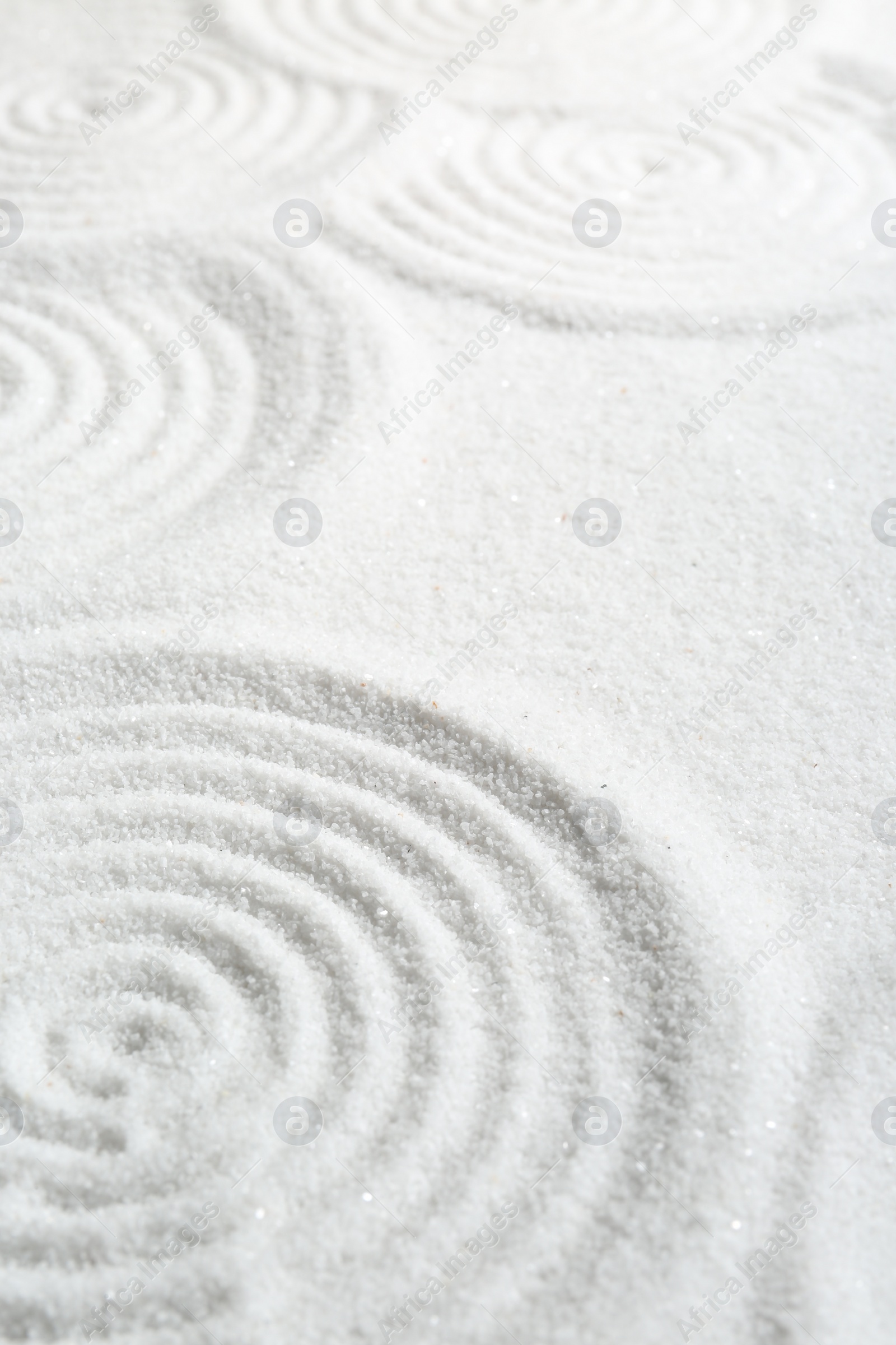 Photo of Zen rock garden. Circle patterns on white sand, closeup