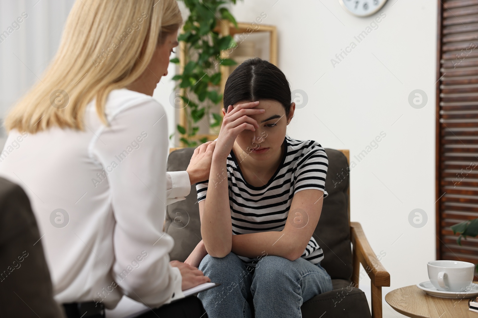 Photo of Psychologist working with teenage girl in office