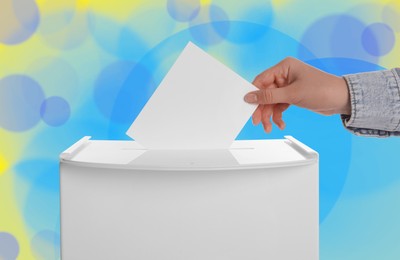 Woman putting her vote into ballot box on color background, closeup