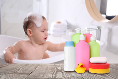 Baby cosmetic products, toy and bathing accessories on table in bathroom