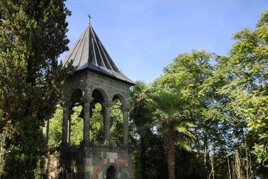 Exterior of beautiful bell tower in park on sunny day