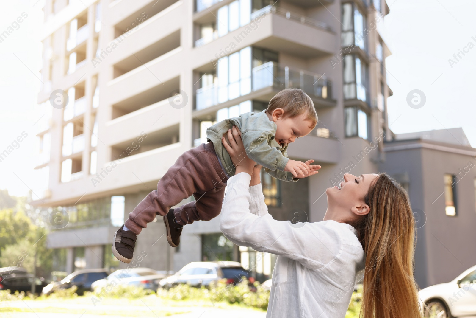 Photo of Happy nanny with cute little boy having fun outdoors