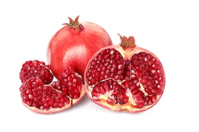 Photo of Cut and whole pomegranates isolated on white