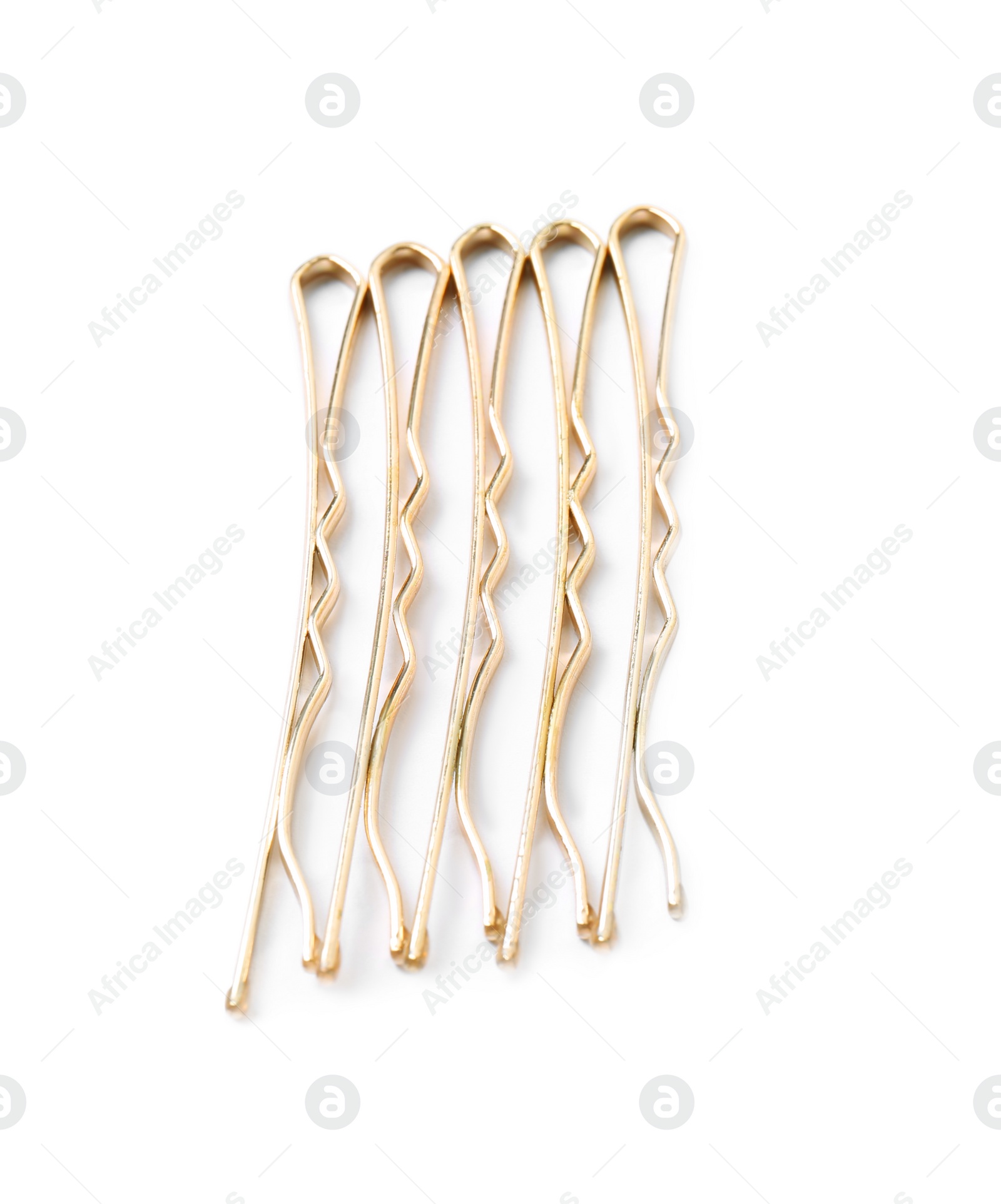 Photo of Many gold hair pins on white background, top view