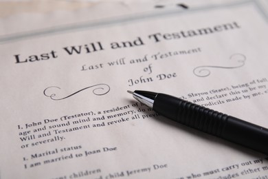 Photo of Last will and testament with pen on table, closeup