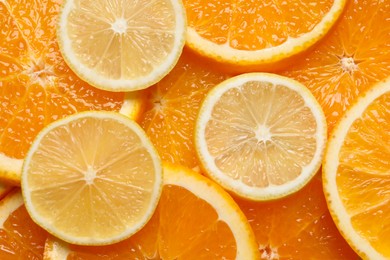 Photo of Slices of lemon and orange as background, top view