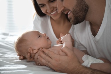Happy couple with their newborn baby at home, closeup