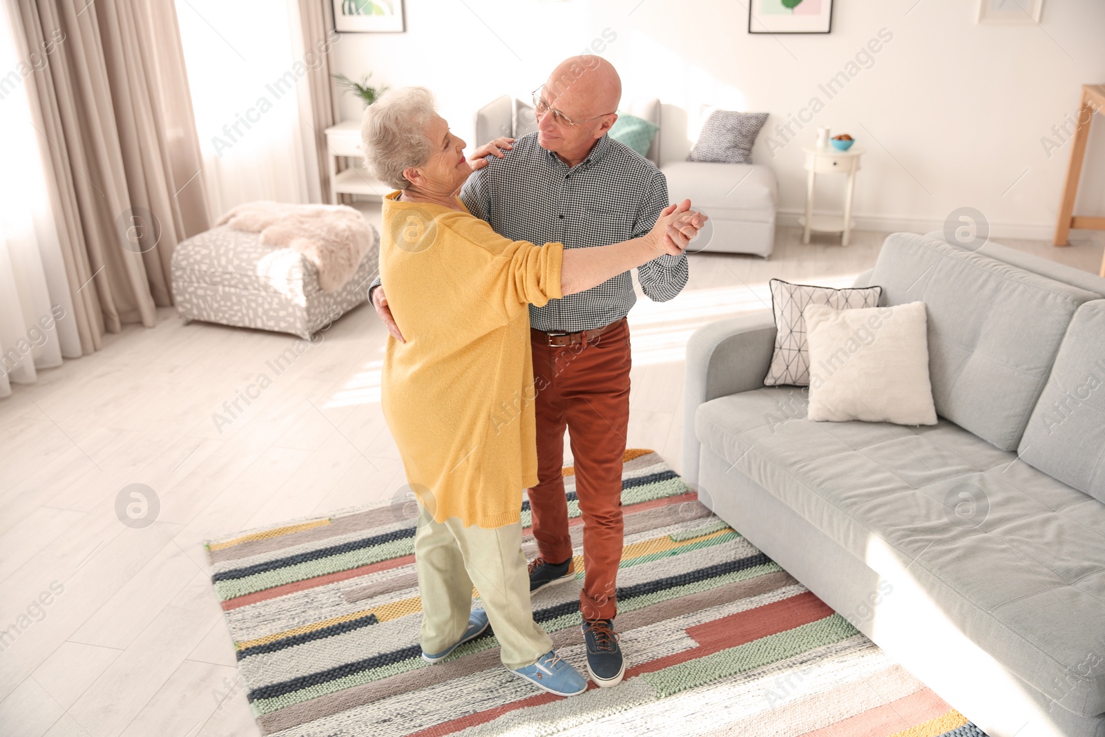 Photo of Elderly couple dancing in living room