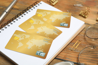 Credit cards and stationery on wooden table, closeup