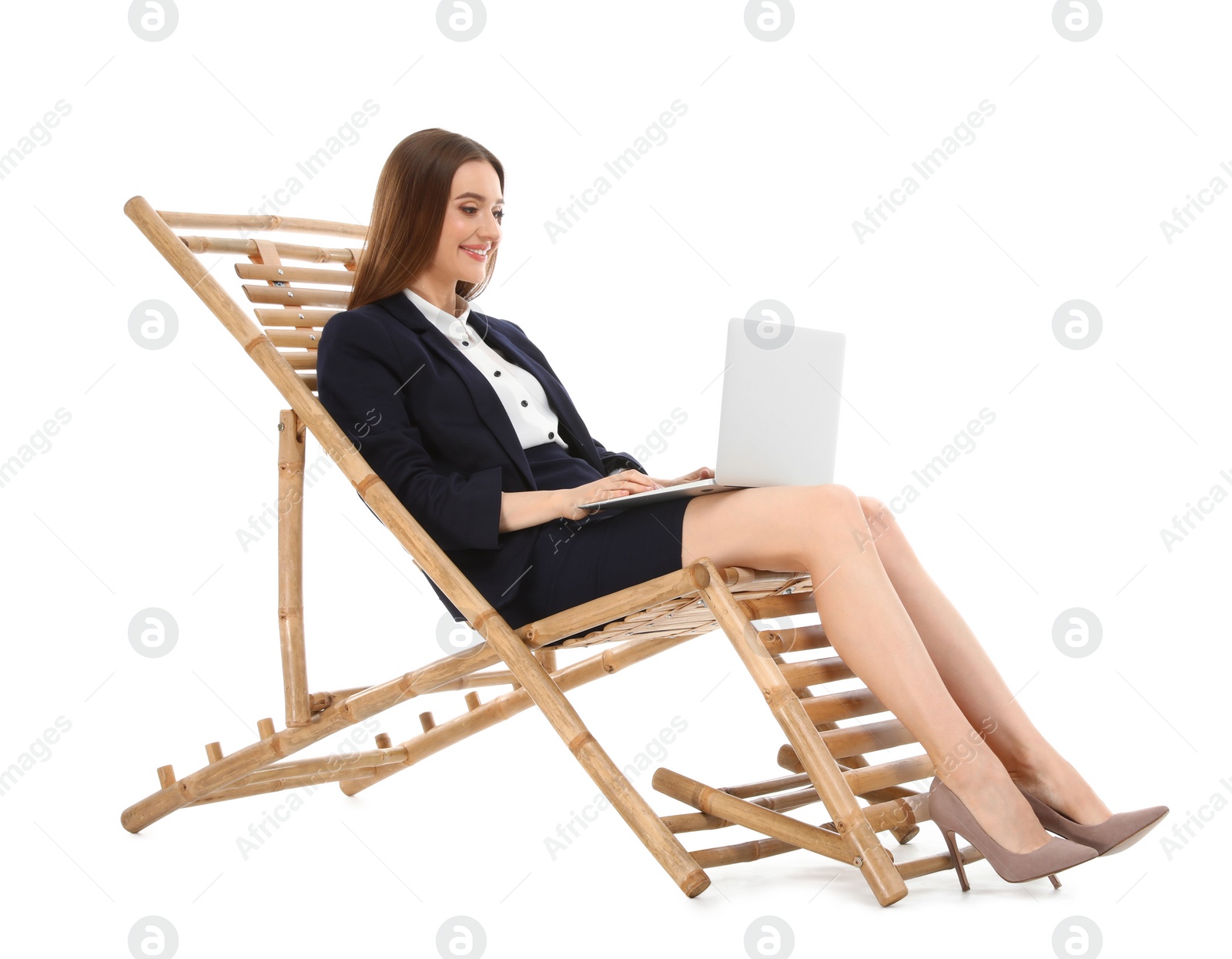 Photo of Young businesswoman with laptop on sun lounger against white background. Beach accessory