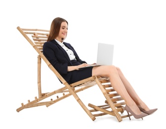 Photo of Young businesswoman with laptop on sun lounger against white background. Beach accessory