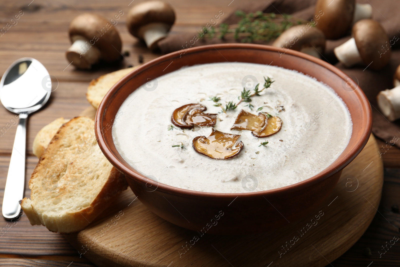 Photo of Fresh homemade mushroom soup served on wooden table