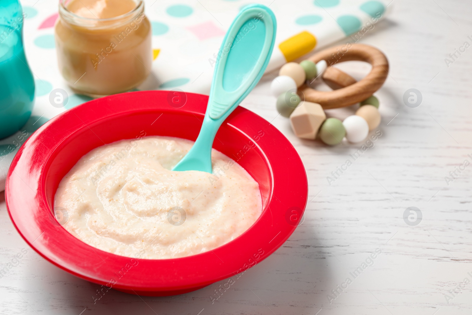 Photo of Healthy baby food on white wooden table, closeup