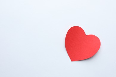 Photo of One paper heart on white background, top view. Space for text