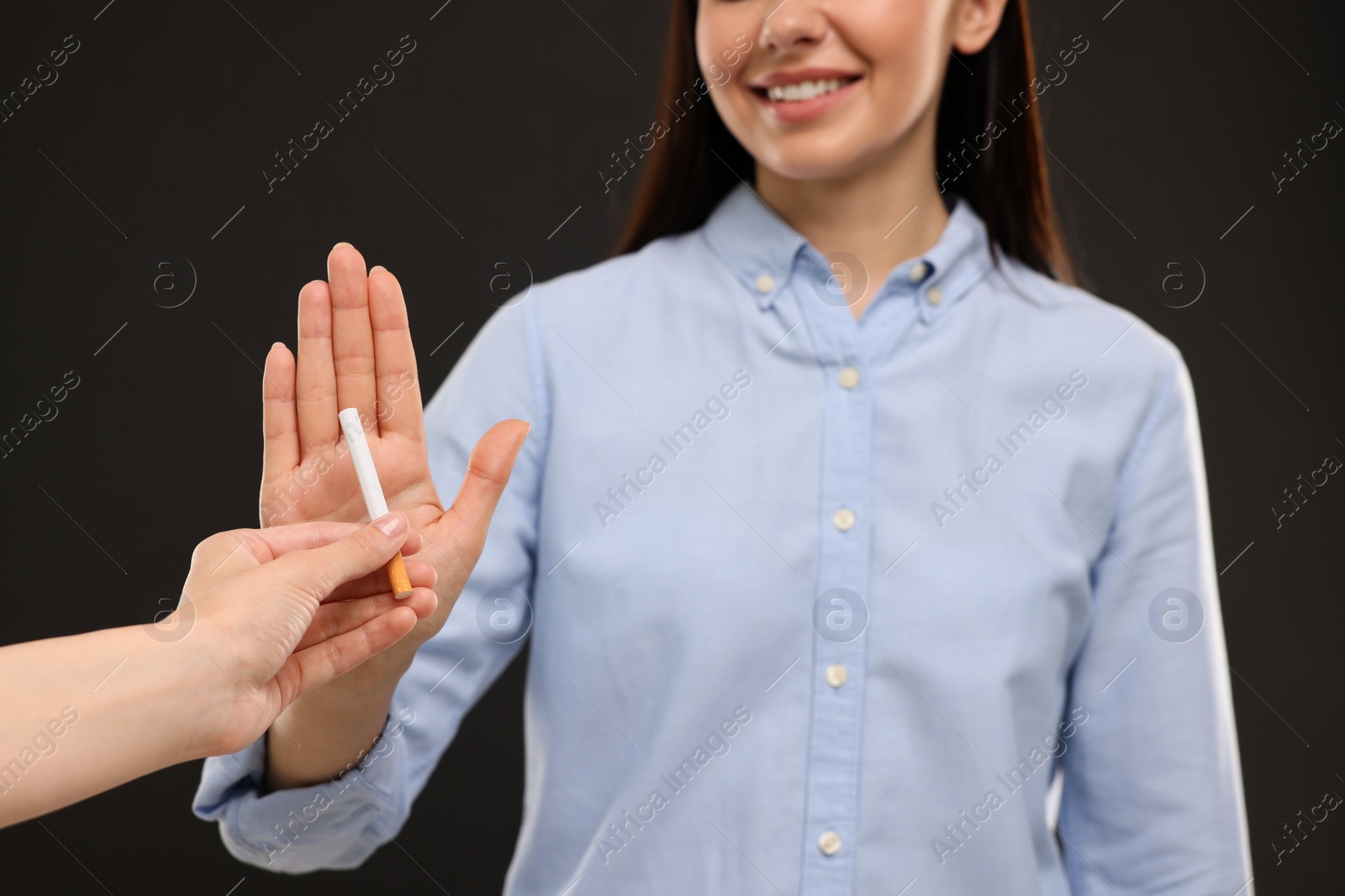 Photo of Stop smoking concept. Woman refusing cigarette on black background, closeup