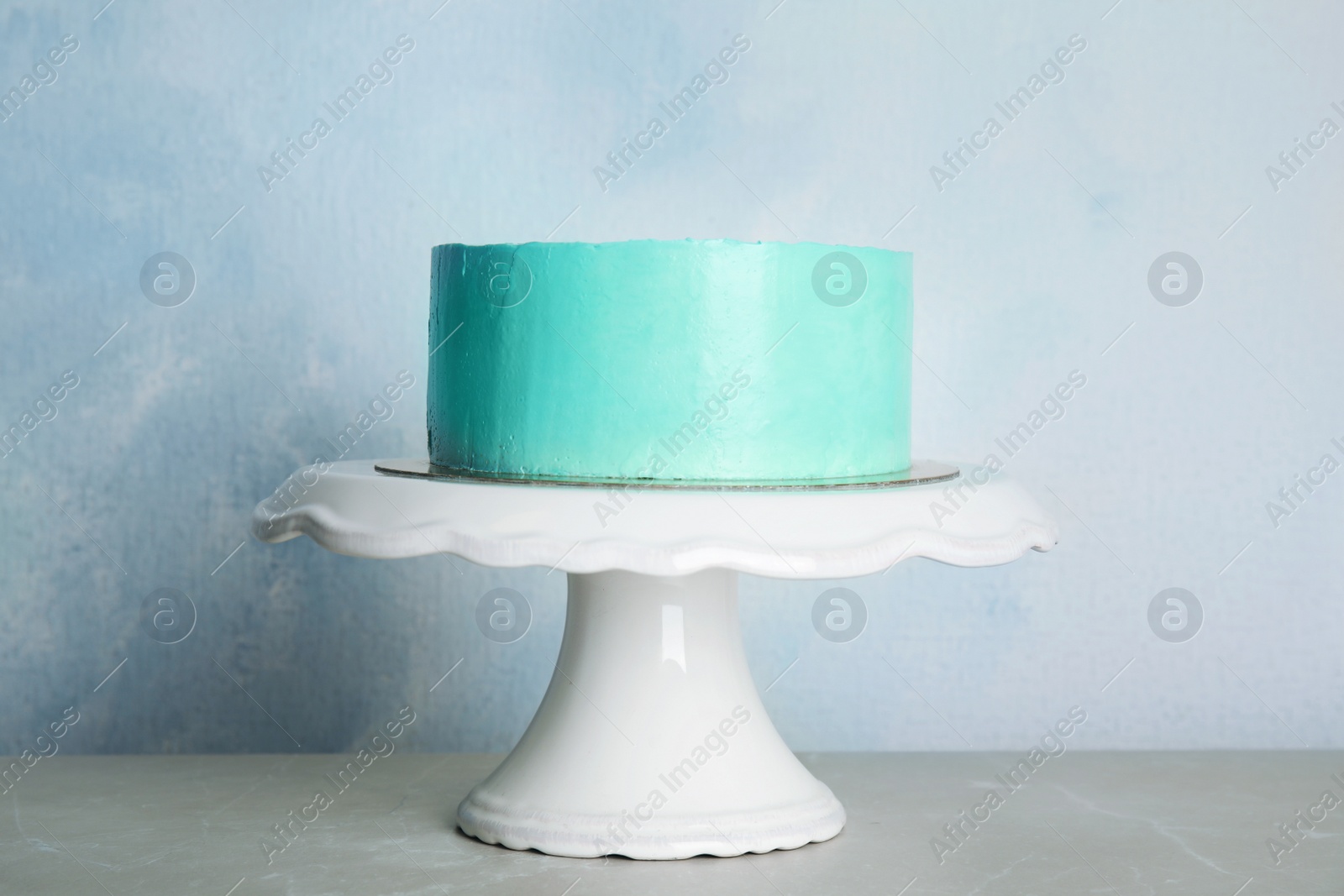 Photo of Fresh delicious birthday cake on stand against color background