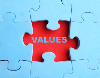 Image of Core values concept. Light blue puzzle with missing piece on red background, top view