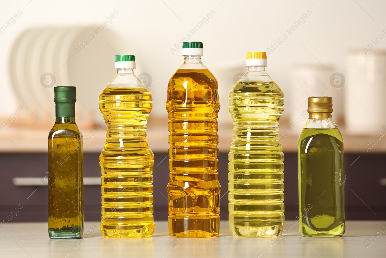 Photo of Bottles of oils on table against blurred background