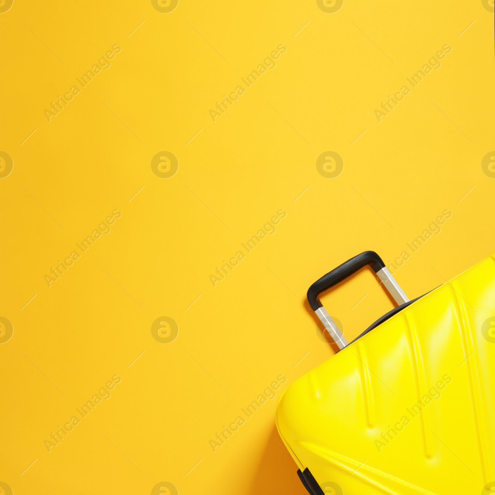 Photo of Bright suitcase on color background, top view with space for text