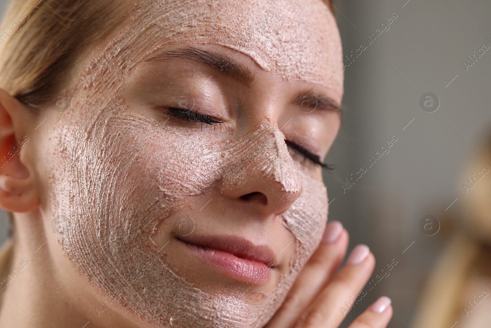 Photo of Woman with face mask on blurred background, closeup and space for text. Spa treatments