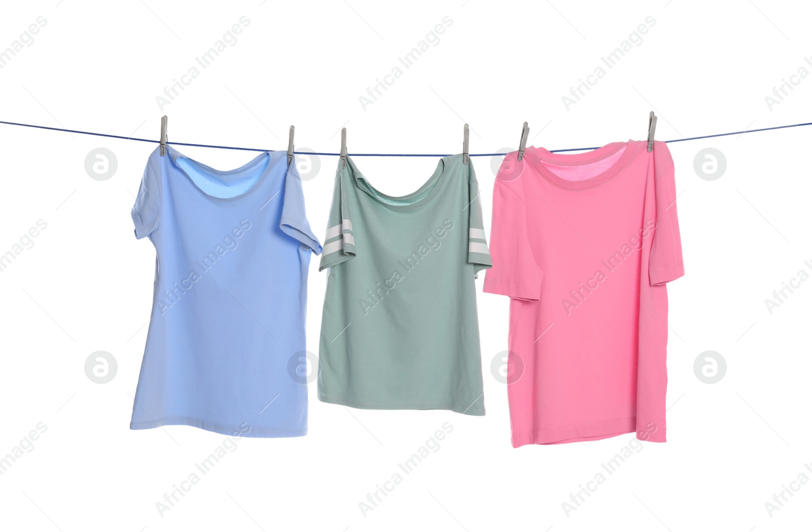 Photo of Different clothes drying on washing line against white background